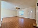 Inviting living room featuring durable wood laminate flooring, ceiling fan, and a bright front door at 248 Arnold Ave, Marietta, GA 30066