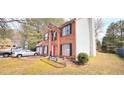Charming brick two-story home with black shutters, two-car garage and lush lawn at 3897 Vine Stone Dr, Stonecrest, GA 30038