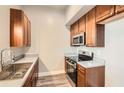 Charming kitchen with stainless steel appliances, warm wood cabinets, and modern finishes at 502 Pryor Sw St # 301, Atlanta, GA 30312