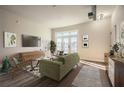 Bright living room featuring hardwood floors, balcony access, and contemporary furnishings at 502 Pryor Sw St # 301, Atlanta, GA 30312