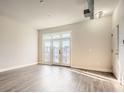 Spacious living room featuring balcony access and modern lighting fixtures at 502 Pryor Sw St # 301, Atlanta, GA 30312