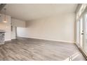 Open concept living space featuring balcony doors, hard wood flooring, and neutral paint colors at 502 Pryor Sw St # 301, Atlanta, GA 30312