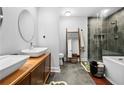 This bathroom features dual sinks, a glass shower, and a modern freestanding soaking tub at 2870 Pharr Ct # 3002, Atlanta, GA 30305