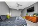 This primary bedroom is complete with a ceiling fan, a TV, and hardwood floors at 2870 Pharr Ct # 3002, Atlanta, GA 30305