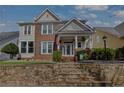 Inviting two-story house featuring a brick facade, landscaped garden, and stone steps to the entrance at 525 Village Arbor Park, Suwanee, GA 30024