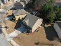 Aerial view of home showing back yard, patio, and suburban neighborhood at 6545 Muirfield Pt, Fairburn, GA 30213