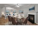 Elegant dining area with a fireplace, mountain view paintings, and hardwood flooring at 145 Sunset Ln, Woodstock, GA 30189