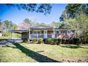 Inviting single-story brick home featuring a cozy covered porch, attached carport, and established landscaping at 5042 Central Church Rd, Douglasville, GA 30135