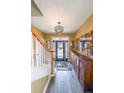 Elegant foyer featuring hardwood floors, staircase, and stylish decor at 2476 Manor Walk, Decatur, GA 30030