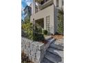 Inviting front entrance with stone steps, a wrought-iron fence, and manicured landscaping at 81 Delmont Ne Dr, Atlanta, GA 30305
