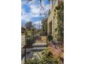Elegant front gate with stone steps leading to a beautifully landscaped yard and charming walkway at 81 Delmont Ne Dr, Atlanta, GA 30305