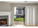 View of a balcony from inside, showcasing white curtains, a fireplace, and sliding glass door at 30 Finch Ne Trl, Atlanta, GA 30308