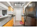 Functional kitchen featuring wood cabinets, black appliances, and ample counter space at 30 Finch Ne Trl, Atlanta, GA 30308