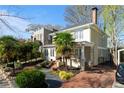 Charming two-story home with brick driveway, mature landscaping, and inviting front porch at 1446 High Point Ne Pl, Atlanta, GA 30306