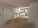 Unfinished kitchen featuring white cabinets, ample space for appliances, and open floorplan at 25 Emerald Ln, Covington, GA 30014