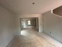Unfinished open-concept living room shows the space with natural light at 25 Emerald Ln, Covington, GA 30014