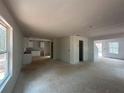 Unfinished living room featuring an open floor plan, natural light and spacious layout at 30 Yellow Brick Way, Covington, GA 30014