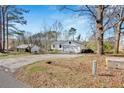 A single Gathering home with a driveway and a garage sits on a spacious property filled with trees at 383 Oakridge Se Dr, Cartersville, GA 30121