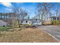 Single story house with a freshly painted exterior, featuring an attached garage and an expansive front lawn at 383 Oakridge Se Dr, Cartersville, GA 30121