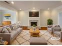 Cozy living room with a brick fireplace, gray furniture, soft rug, and bright natural light at 45 Fiddle Crk, Social Circle, GA 30025