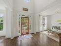 Bright foyer with hardwood floors, soaring ceilings, transom windows, and a beautiful front door at 102 Stargaze Rdg, Canton, GA 30114