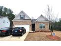 Charming brick home with a two-car garage and well-maintained front lawn at 1125 Campbell Pine Trl, Lawrenceville, GA 30045