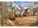 Beautiful brick home with mature trees and inviting curb appeal, offering a serene and private setting at 418 Abbey Springs Way, Mcdonough, GA 30253