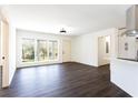 Bright living room with an open layout, featuring hardwood flooring and a large window overlooking the front yard at 618 Farrar Ct, Decatur, GA 30032