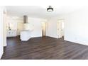 Bright and open living room featuring sleek dark hardwood flooring and neutral walls throughout at 618 Farrar Ct, Decatur, GA 30032