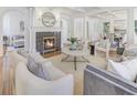 Elegant living room featuring a fireplace, coffered ceiling, and neutral color palette. A cozy space for gatherings at 232 Westminster Ne Dr, Atlanta, GA 30309