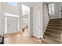 Bright foyer with hardwood floors, staircase, and a view into other rooms at 3350 Fieldwood Se Dr, Smyrna, GA 30080