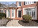 Inviting brick entryway with a black front door and manicured landscaping at 3350 Fieldwood Se Dr, Smyrna, GA 30080