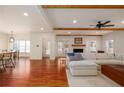 Open concept living room showcasing hardwood floors, a fireplace, and seamless flow to the dining area, perfect for entertaining at 827 Derrydown Way, Decatur, GA 30030