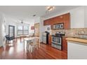 View of a dining area, living area and kitchen featuring stainless steel appliances and hardwood floors at 898 Oak Sw St # 3222, Atlanta, GA 30310