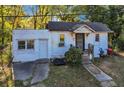 A charming front exterior view showcases a cozy home with a covered porch, inviting entryway, and quaint curb appeal at 1653 Richmond Se Ave, Atlanta, GA 30315