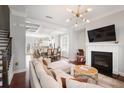 Open-concept living space with fireplace, seamlessly connecting to the dining area at 1800 Morning Glory Ne Ln, Atlanta, GA 30324