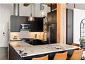 Bright kitchen boasts black cabinetry, stone counters, and stainless appliances at 170 Boulevard Se # H213, Atlanta, GA 30312