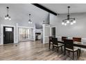 Open-concept living and dining area with gray paint, hardwood flooring, and modern lighting at 9760 Greenside Way, Douglasville, GA 30135