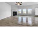 Spacious living room featuring a fireplace and sleek hardwood floors at 27 Crescent Chase, Dallas, GA 30157