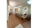 Bright living room featuring hardwood floors, ceiling fan and a fireplace at 317 Glens Way, Woodstock, GA 30188