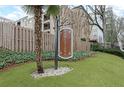 A decorative sign marks the entrance to Barcelona Condominiums, surrounded by lush landscaping and mature trees at 395 Pharr Ne Rd # 305, Atlanta, GA 30305