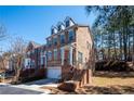 Attractive brick townhome with a two-car garage and manicured lawn at 402 Iona Abbey Se Ct, Smyrna, GA 30082