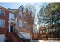 Brick townhome exterior with stately columns and well-maintained landscaping at 402 Iona Abbey Se Ct, Smyrna, GA 30082