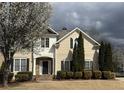 Inviting two-story home featuring a well-maintained lawn, stone accents, and attractive landscaping at 1919 Barrett Knoll Nw Cir, Kennesaw, GA 30152