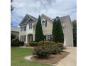 Inviting home exterior with lush greenery, including evergreen trees and roses at 1919 Barrett Knoll Nw Cir, Kennesaw, GA 30152