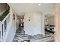 Inviting foyer with light gray walls, wood-look floors, and staircase leading to the upper level at 3370 Flagstone Trce, Ellenwood, GA 30294