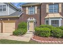 Close-up of the front door with manicured shrubs and mulched flower beds at 3370 Flagstone Trce, Ellenwood, GA 30294