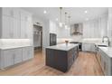 Modern kitchen with white cabinets, stainless steel appliances, and center island is perfect for cooking and entertaining at 4827 Basingstoke Dr, Suwanee, GA 30024