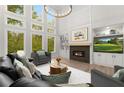 Bright living room with a fireplace, large windows, high ceilings and recessed lighting at 4827 Basingstoke Dr, Suwanee, GA 30024