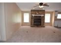 Spacious living room featuring a stone fireplace and large windows for natural light at 59 Pine Ridge Ln, White, GA 30184